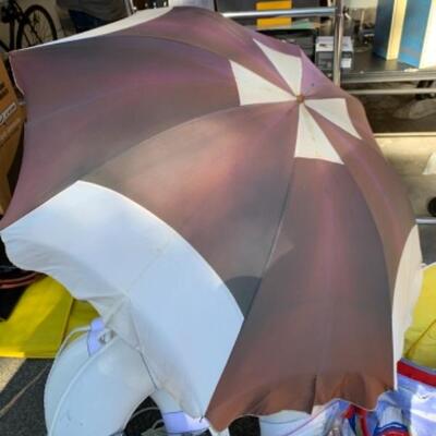 Lot 109. Three umbrellas with table brackets, one tote, flags, two life bests, and 2 life preservers, etc,--$65