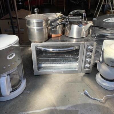 Lot 113. Collection of small appliancesâ€”coffee maker, dehydrater, tea maker, electric kettle, pressure cooker, Kitchen Aid toaster oven...
