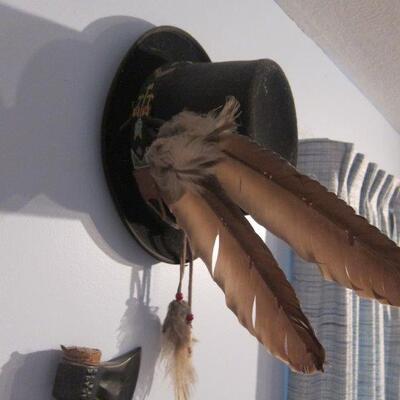Collection of cowbow hats, Indian headpeice and tamahawks