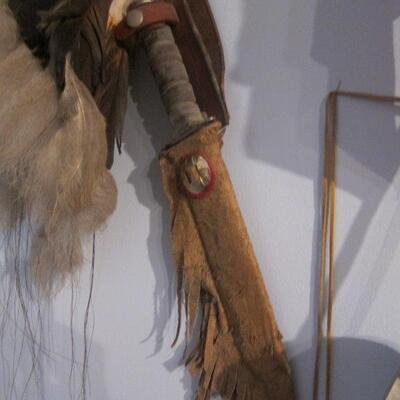 Collection of cowbow hats, Indian headpeice and tamahawks