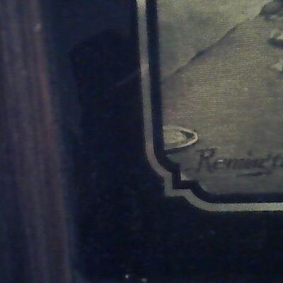 Remington gold  art work framed in wood