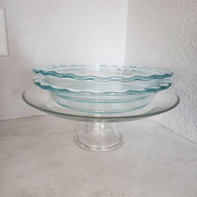 Lot 143: Glass Pie/Cake Stand & 2 Pyrex Pie Platea