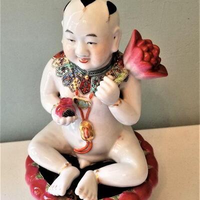 Lot #62  Ceramic Asian Figure holding Lotus Blossom