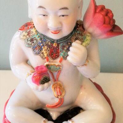 Lot #62  Ceramic Asian Figure holding Lotus Blossom