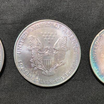 Lot 127 -  Coins and Silver (5 Silver Eagles and a 1998 Merry Christmas Coin)