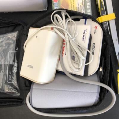 Lot 38U. Travel and Health accessoriesâ€”mugs and heater, 2 blood pressure monitors (new), travel clocks, scale, mirror foldable grabber,...