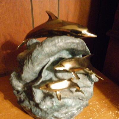 "Hand Sculpture Dolphin's by Dan Parker."