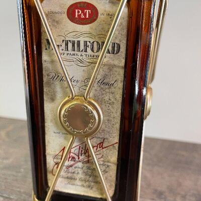 L154: Mr. Tilford whiskey Blend On metal stands on music box