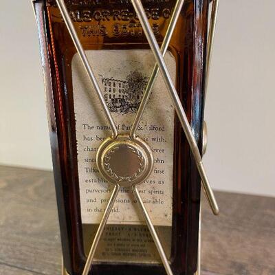 L154: Mr. Tilford whiskey Blend On metal stands on music box