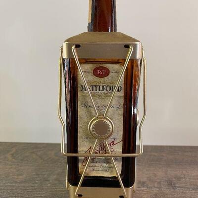 L154: Mr. Tilford whiskey Blend On metal stands on music box