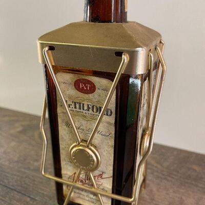 L154: Mr. Tilford whiskey Blend On metal stands on music box