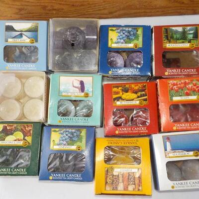12 boxes of  tea lite candles assorted scents.