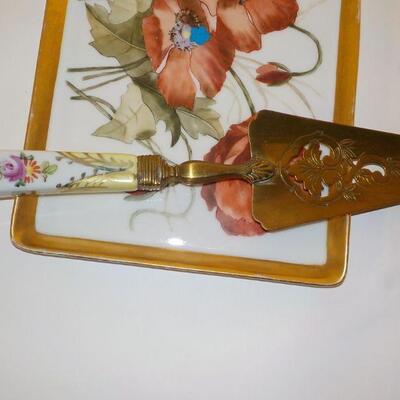 vintage ceramic serving plate and knife with Waterford Vase.