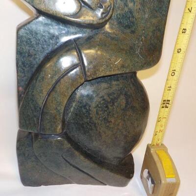 African carved serpentine stone sculpture of two people. Signed â€œH. Ncubeâ€  Likely from Zimbabwe.