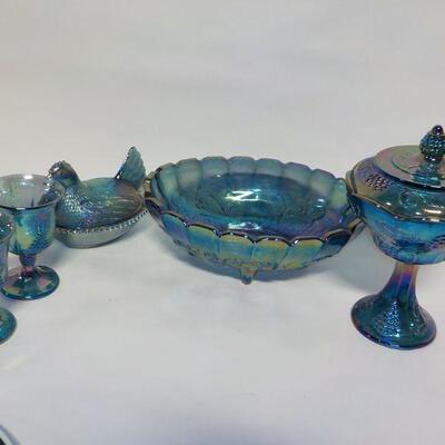 Vintage Blue Carnival Glass  blue iridescent carnival glass: footed candy dish with lid, two goblets, oval footed bowl with fruit on...