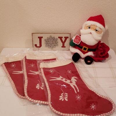 Lot 235: NEW (3) Christmas Stockings, Santa Plushie & JOY Sign