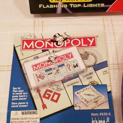Lot 277:  New Flying Disk, Monopoly Keychain Game & Flashlight