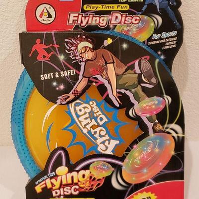 Lot 277:  New Flying Disk, Monopoly Keychain Game & Flashlight