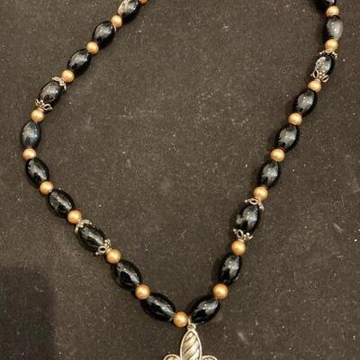 Beautiful black glass bead and silver toned fleur de Lis pendant
