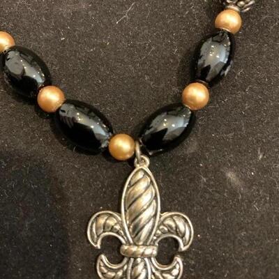 Beautiful black glass bead and silver toned fleur de Lis pendant