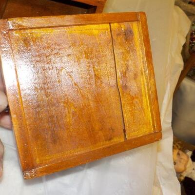 Vintage coffee grinder and wood boat model.