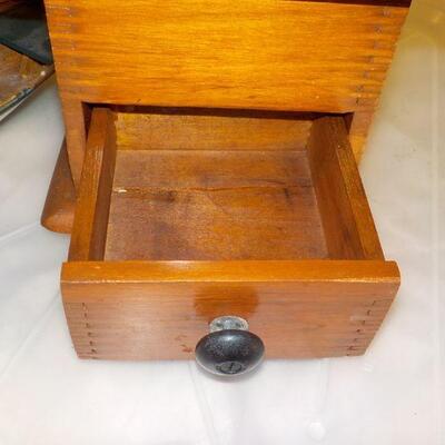 Vintage coffee grinder and wood boat model.