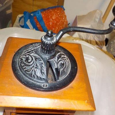 Vintage coffee grinder and wood boat model.