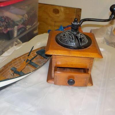 Vintage coffee grinder and wood boat model.