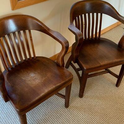 Two antique wooden office chairs