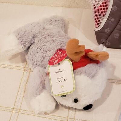 Lot 480: NEW Jingle All the Way DVD and Jingle Plushie and Jingle Dog Bed 