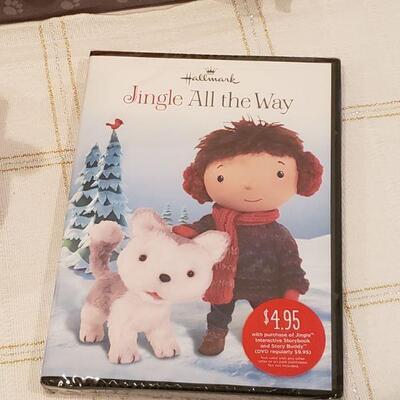 Lot 480: NEW Jingle All the Way DVD and Jingle Plushie and Jingle Dog Bed 