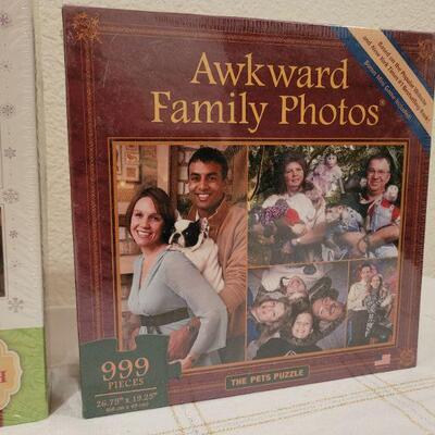 Lot 645: NEW Springbok 1000 pcs Puzzle and AWKWARD Family Photos 999 pcs 