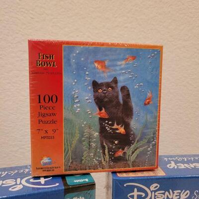 Lot 653: Mickey and Pooh NEW Puzzles 500 pc + 100 pc New Cat Puzzle
