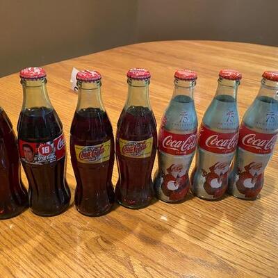 7 Coca Cola bottles