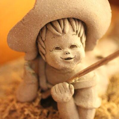 Lot 61 Boy Fishing Sculpture on Log 