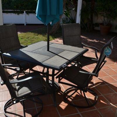LOT 49 PATIO SET WITH FOUR SWIVEL CHAIRS AND UMBRELLA