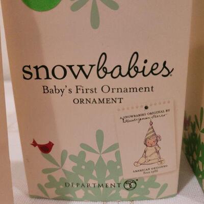 Lot 717: Assorted Dept 56 Snowbabies Christmas Figures + Ornament Stand