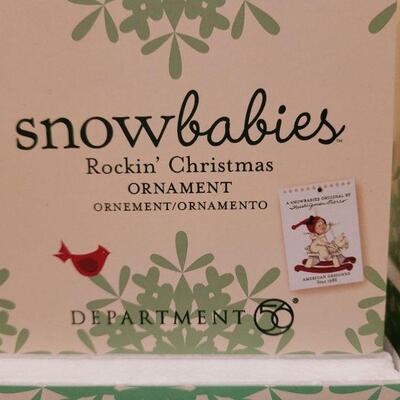 Lot 717: Assorted Dept 56 Snowbabies Christmas Figures + Ornament Stand