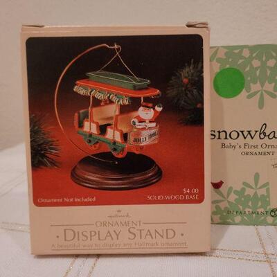 Lot 717: Assorted Dept 56 Snowbabies Christmas Figures + Ornament Stand