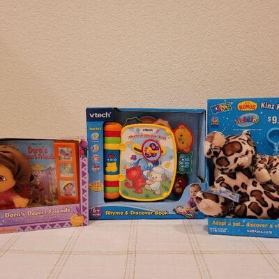 Lot 723: V Tech Rhyme and Discover Tablet + Stuffed Animal and DORA book