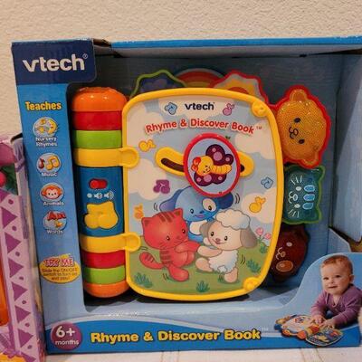 Lot 723: V Tech Rhyme and Discover Tablet + Stuffed Animal and DORA book