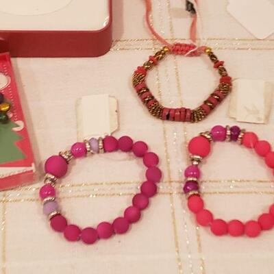 Lot 792: NEW (3) Bracelets, Jingle Bells Earrings, Christmas Dog Socks, Tin with Tissues, Santa Wish Box, HELLO KITTY Plushie