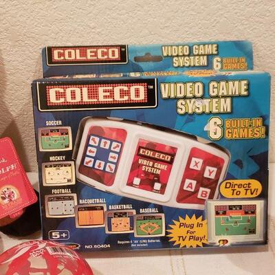 Lot 814: New Video Game, Bouncy Ball, Hot Cocoa Cup and Reindeer Plushie