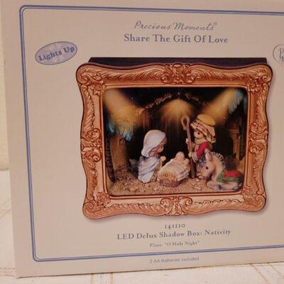 Lot 884: Precious Moments LED Nativity + Hallmark Ornament 