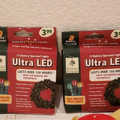 Lot 917: New Macy's Stockings, Polar Express Stocking Hanger, LED Wreath Lights and Candle