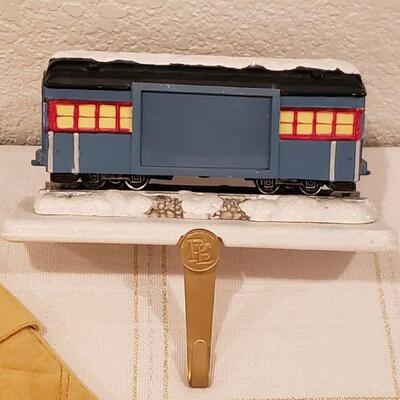 Lot 917: New Macy's Stockings, Polar Express Stocking Hanger, LED Wreath Lights and Candle