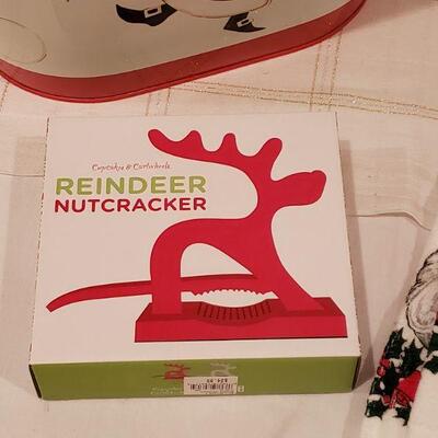 Lot 919: New Holiday Reindeer Nuts, Hand Towels, Glass Light Up Santa and Santa Metal Container