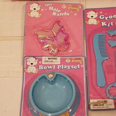 Lot 944: NEW Puppy and Puppy Dress Up, Grooming and Feeding Sets