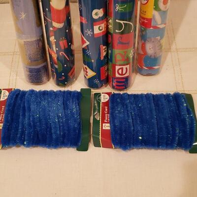 Lot 967: NEW (5) Rolls of Wrapping Paper (blues)  and Blue Fuzzy Wire Trim 