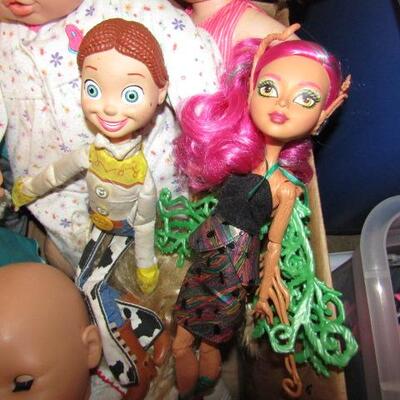 LOT 150  BOX OF BABY DOLLS TOY STORY JESSIE AND MORE